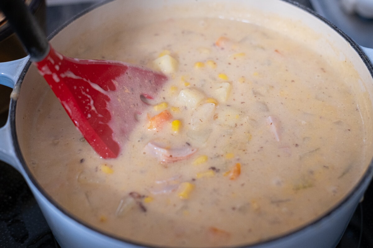 Bacon, onions, carrots, potatoes, corn, chicken bouillon, and milk in a heavy-bottomed pot. 